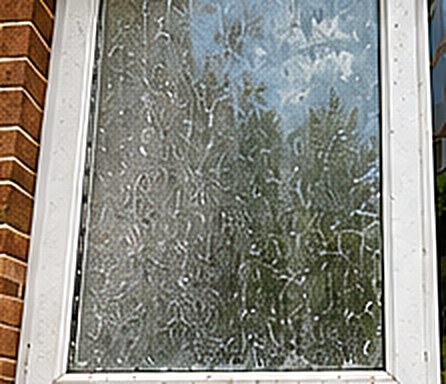Window before cleaning, glass covered in grime